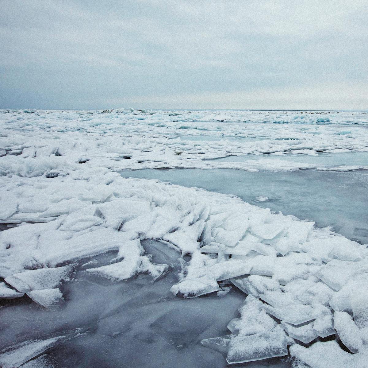 Vast frozen sea with cracked ice formations stretching to the horizon