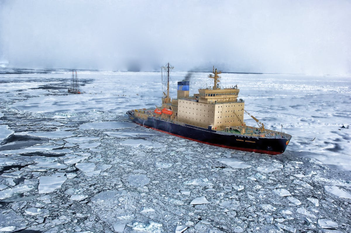 Icebreaker ship cutting through frozen ocean waters