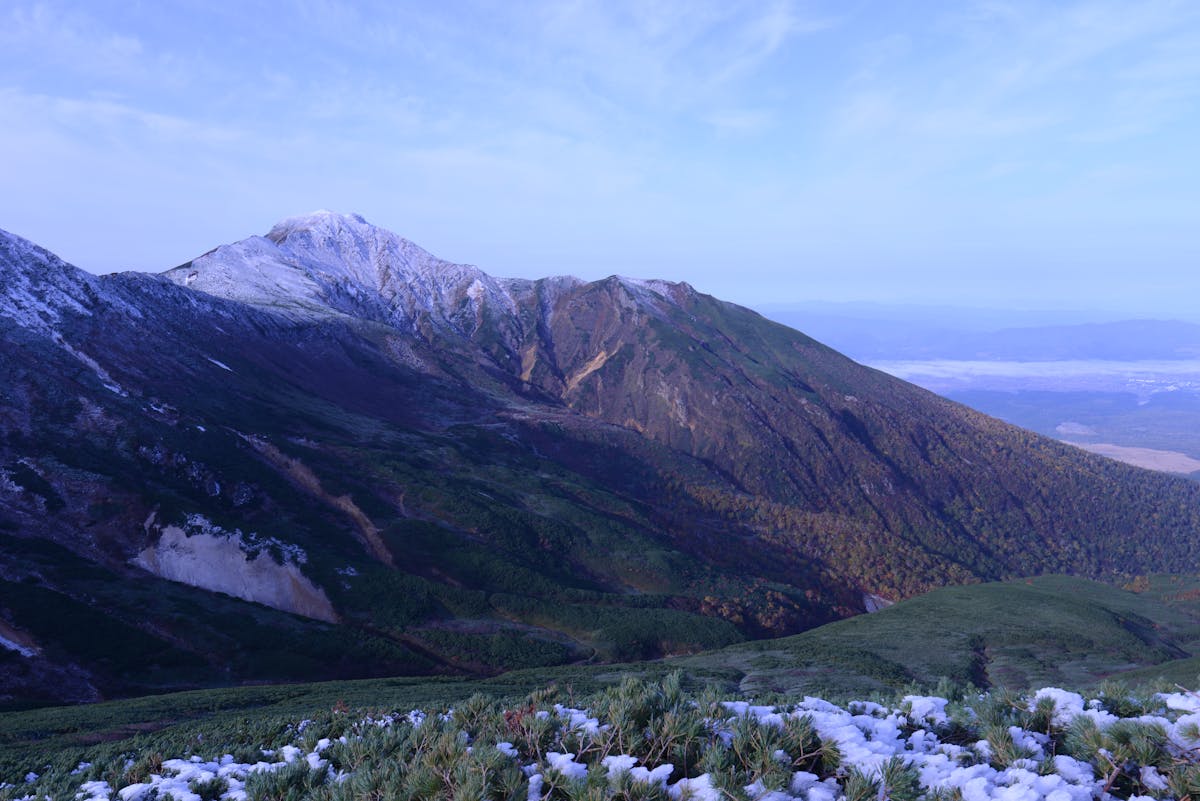 Snowcapped mountains and lush valleys panorama in Hokkaido
