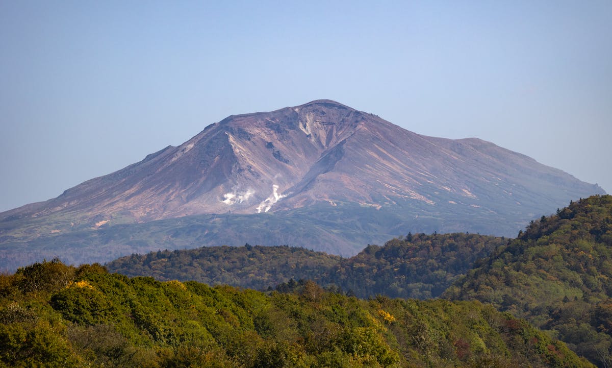 Volcanic mountain surrounded by forest in Hokkaido Japan