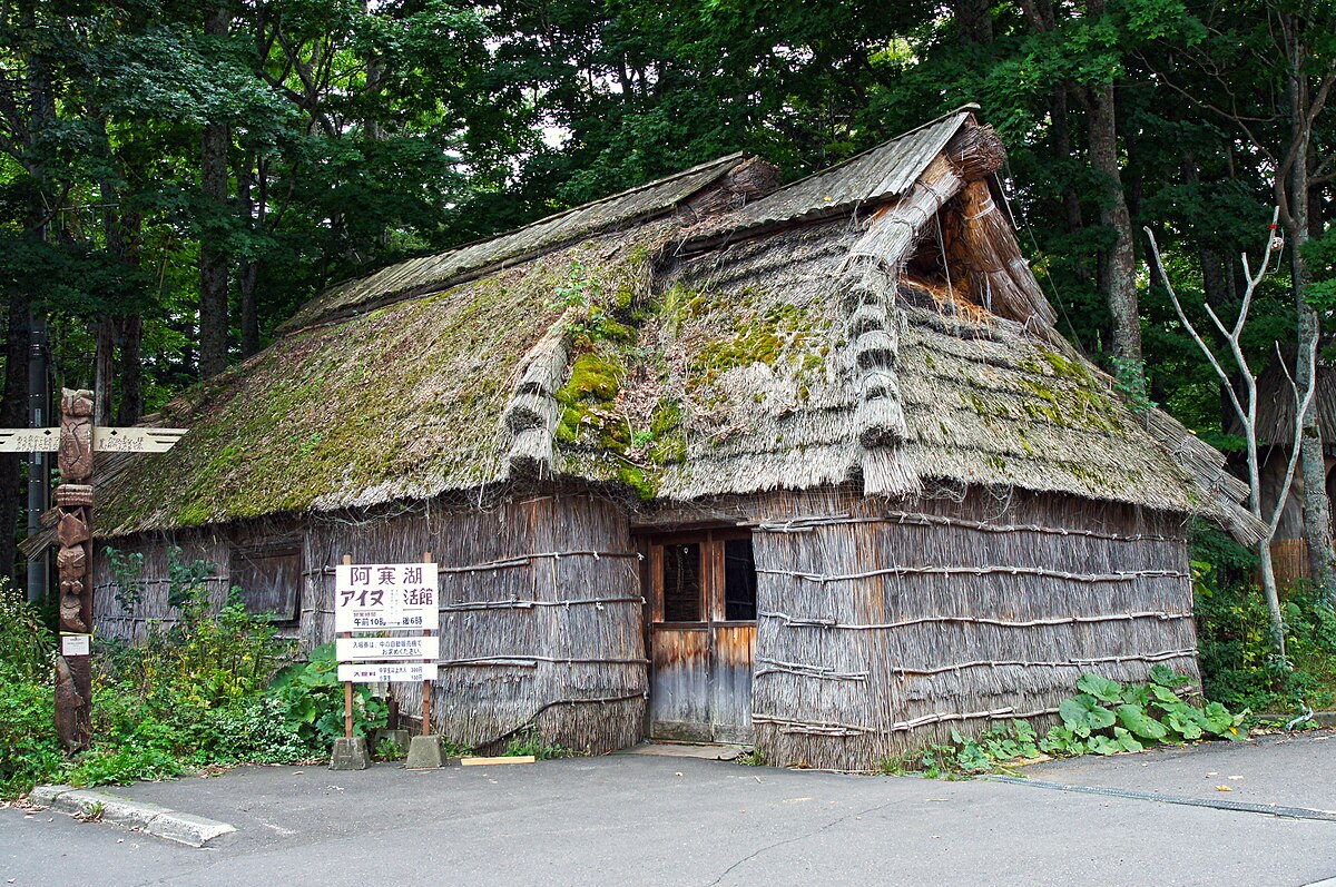 Ainu Kotan village entrance with traditional carved wooden owl statue in Akan