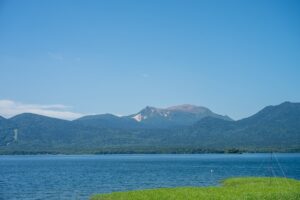 Lake Akan with blue waters and mountain backdrop in Hokkaido Japan