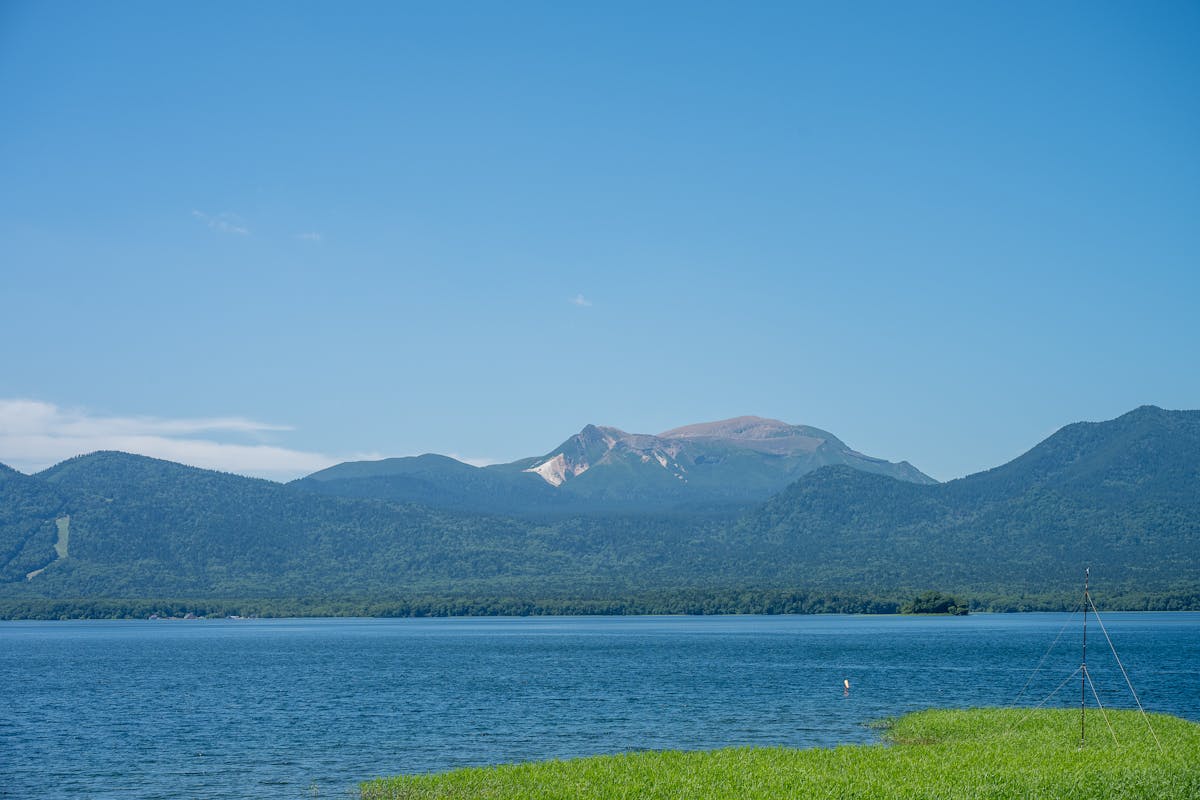 Lake Akan with blue waters and mountain backdrop in Hokkaido Japan