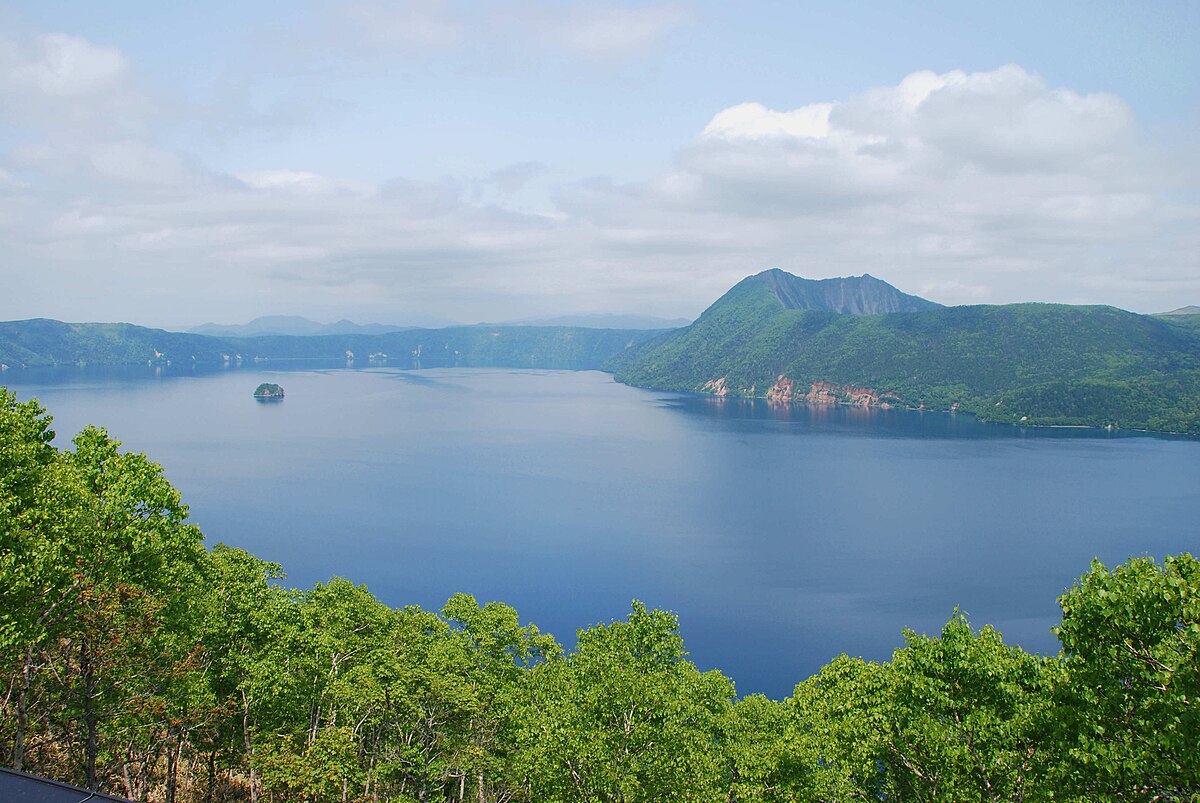 Lake Mashu caldera lake with deep blue water surrounded by steep crater walls