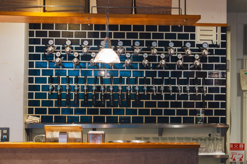 Modern craft beer bar interior with multiple beer taps in Japan