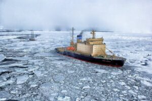 Icebreaker ship navigating through frozen sea ice