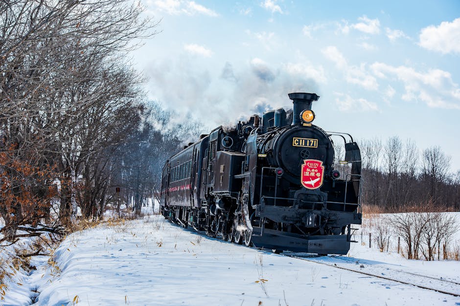 Steam train traveling through snowy winter landscape in Hokkaido