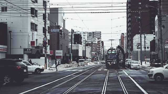 Snowy street in Sapporo Hokkaido with cars and buildings