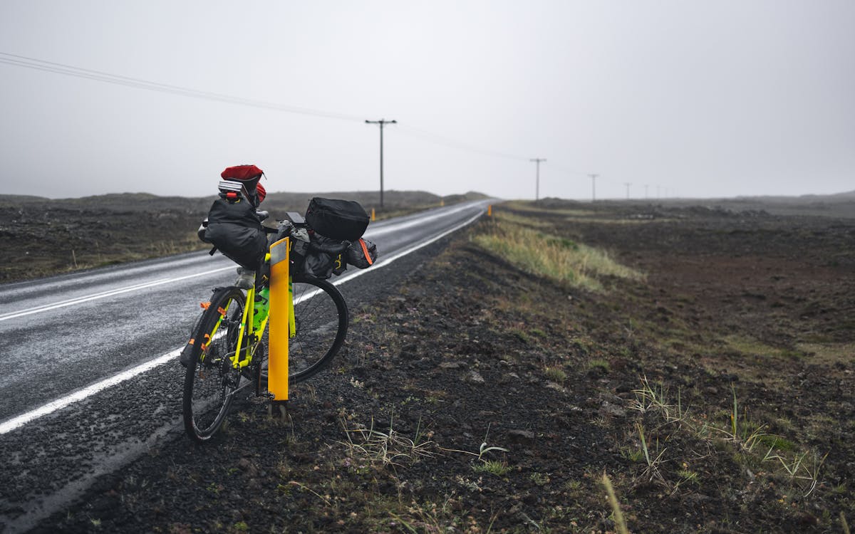 Bicycle loaded with bags parked on a roadside ready for touring