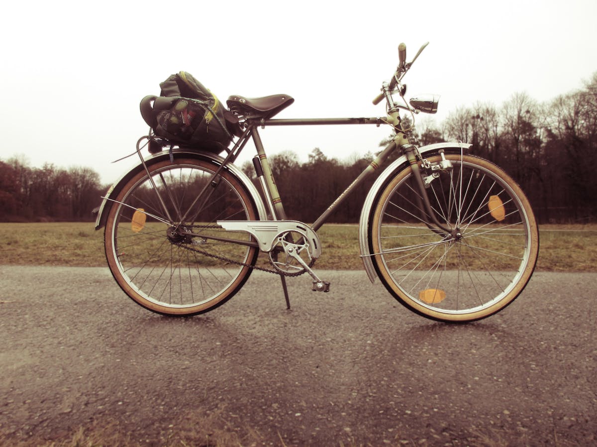 Classic touring bicycle with panniers on an empty country road