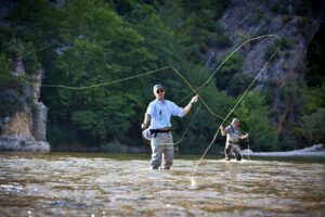 Angler fly fishing in a river