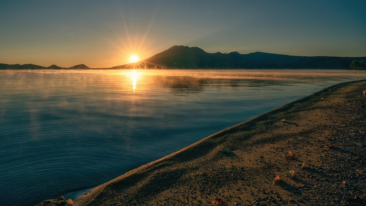 Lake Shikotsu at sunrise with mist over the water in Hokkaido