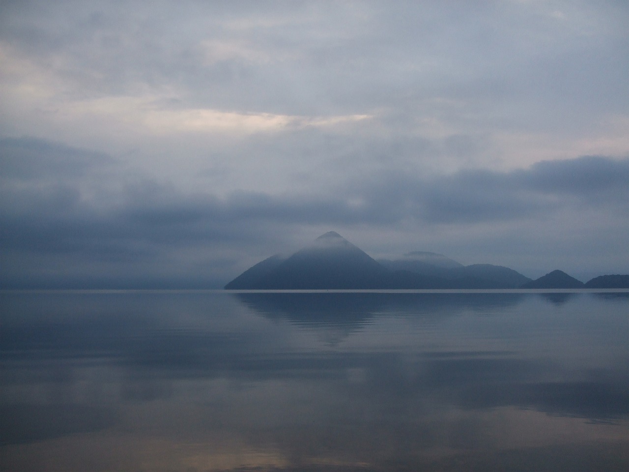 Lake Toya in Hokkaido with mountains in the background and calm water