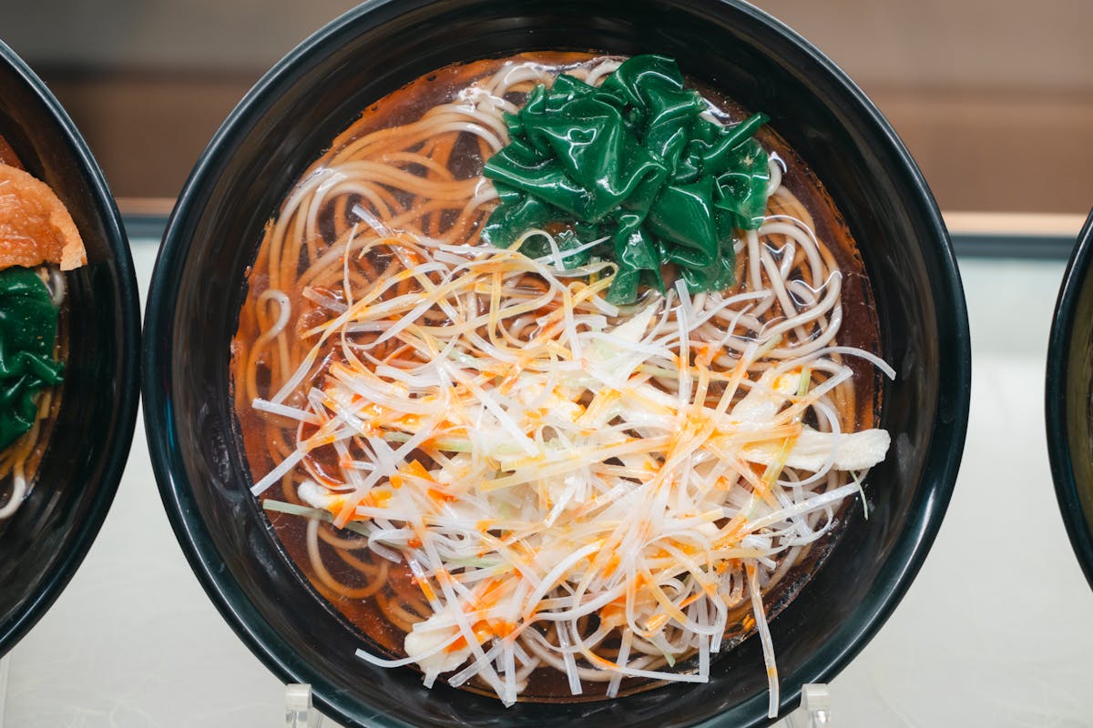 Top view of a ramen bowl with noodles and toppings