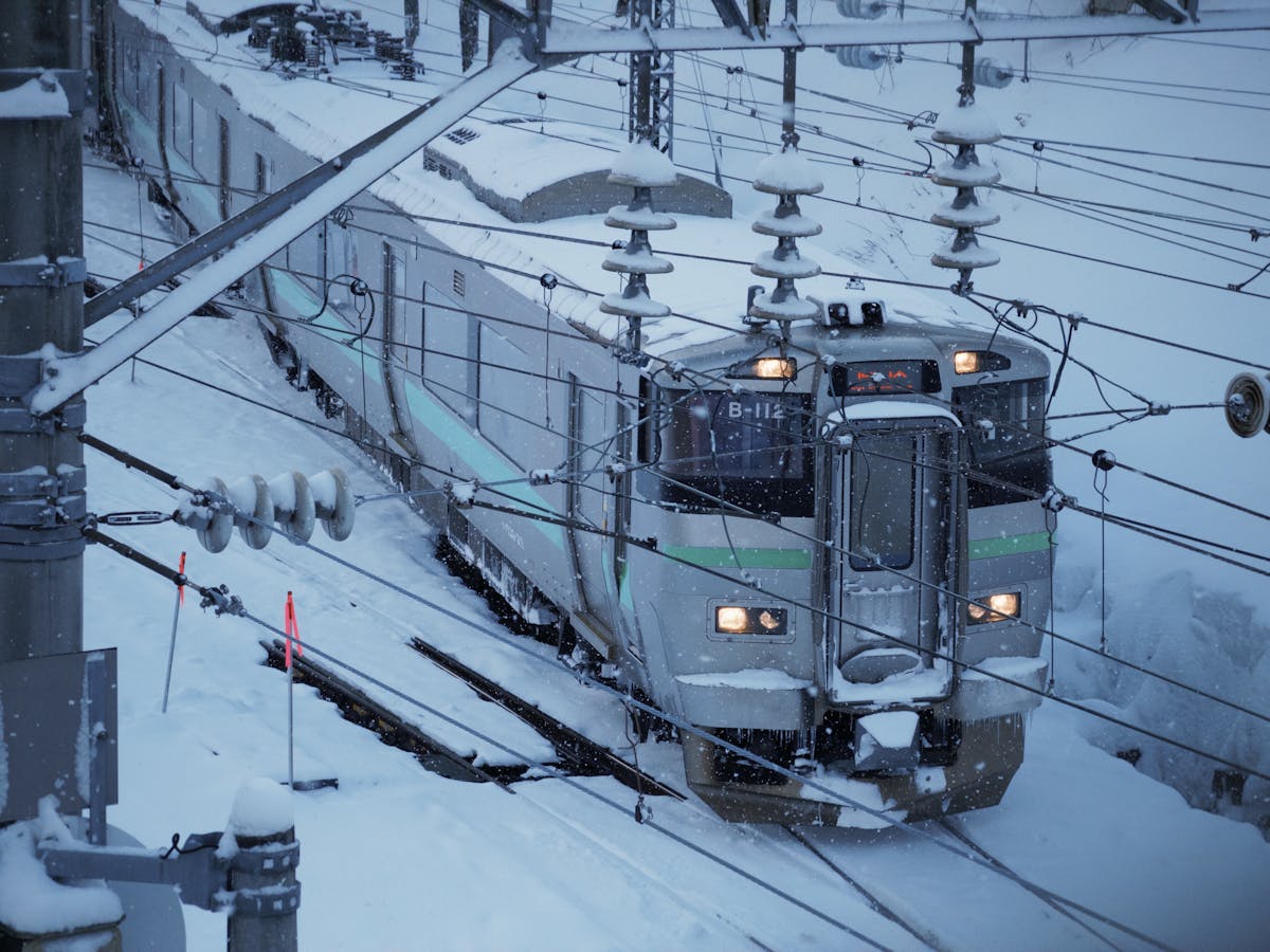 Snow-covered train on winter railway track in Otaru, Hokkaido, Japan
