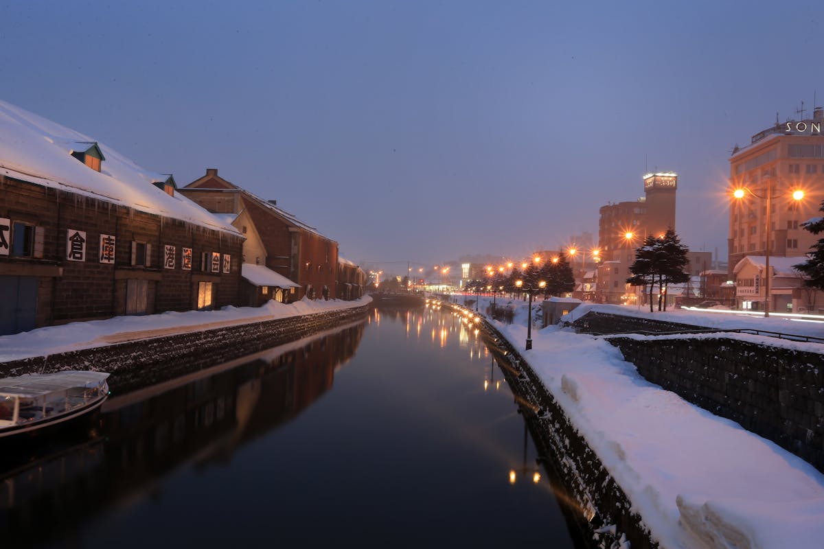 Winter evening view of Otaru Canal in Hokkaido with snow and lights