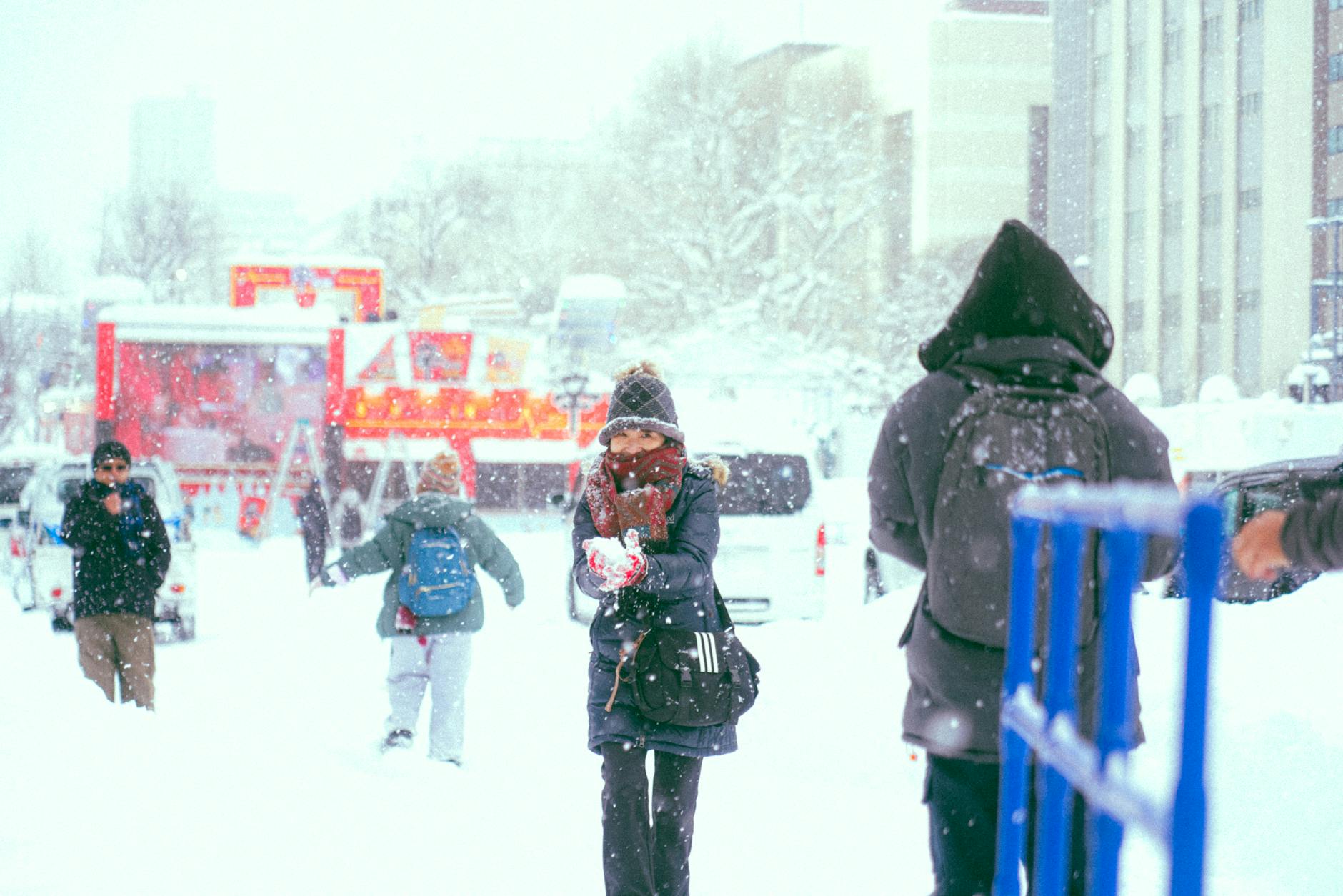 People walking through a snowy winter street scene in Japan