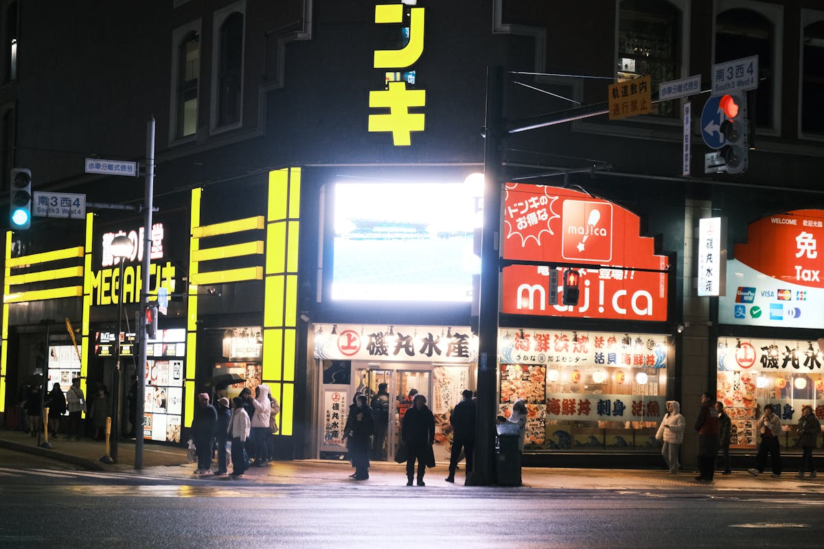 Night street scene in Sapporo Hokkaido with restaurant signs