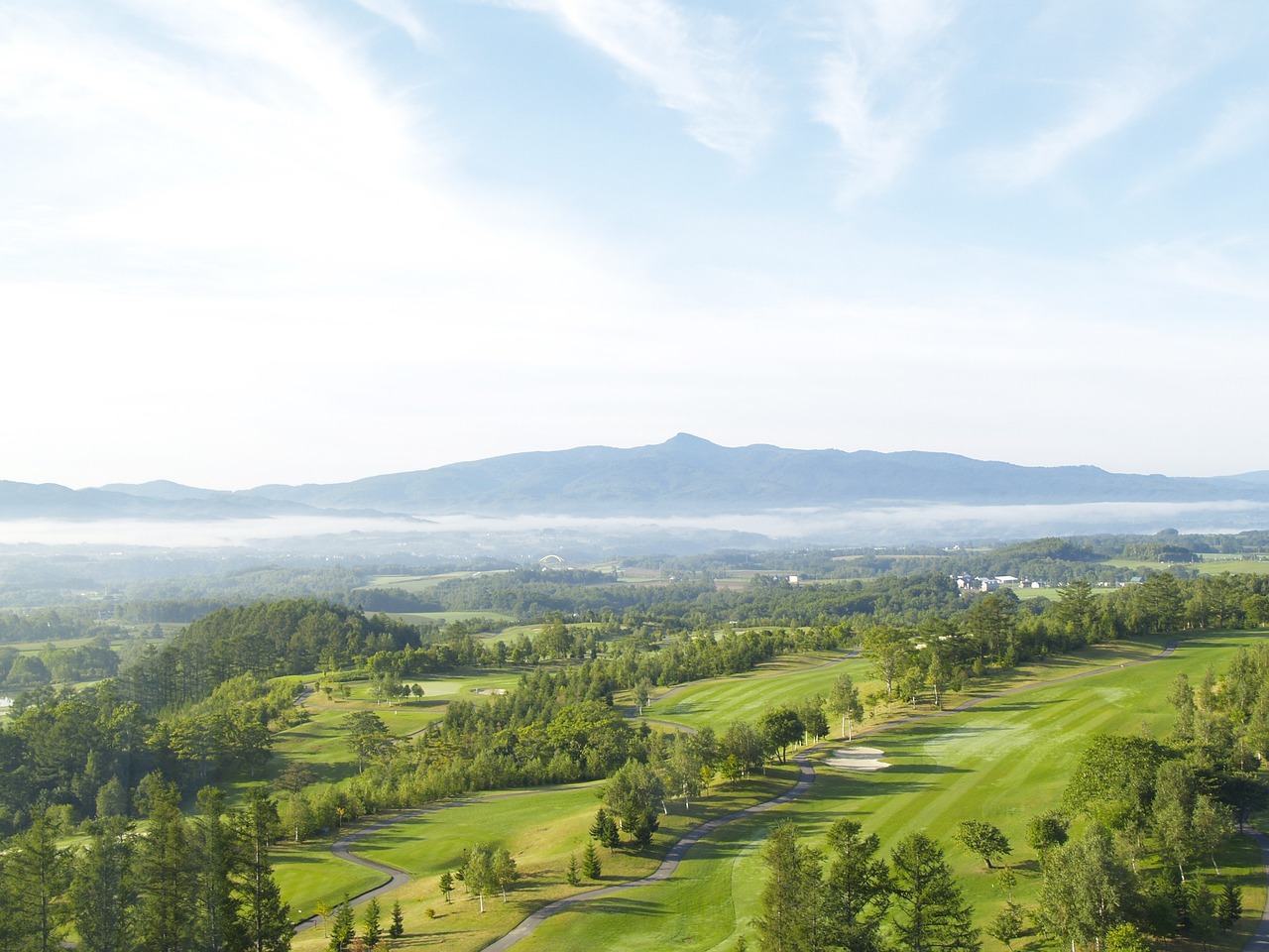 Green rolling hills and farmland in Niseko, Hokkaido during summer