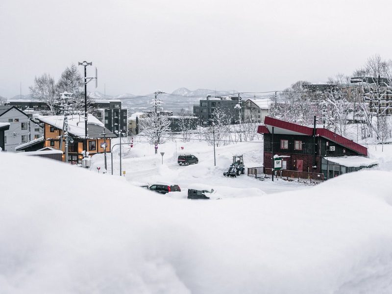 Serene winter scene of a tranquil village covered in snow in Niseko Hokkaido