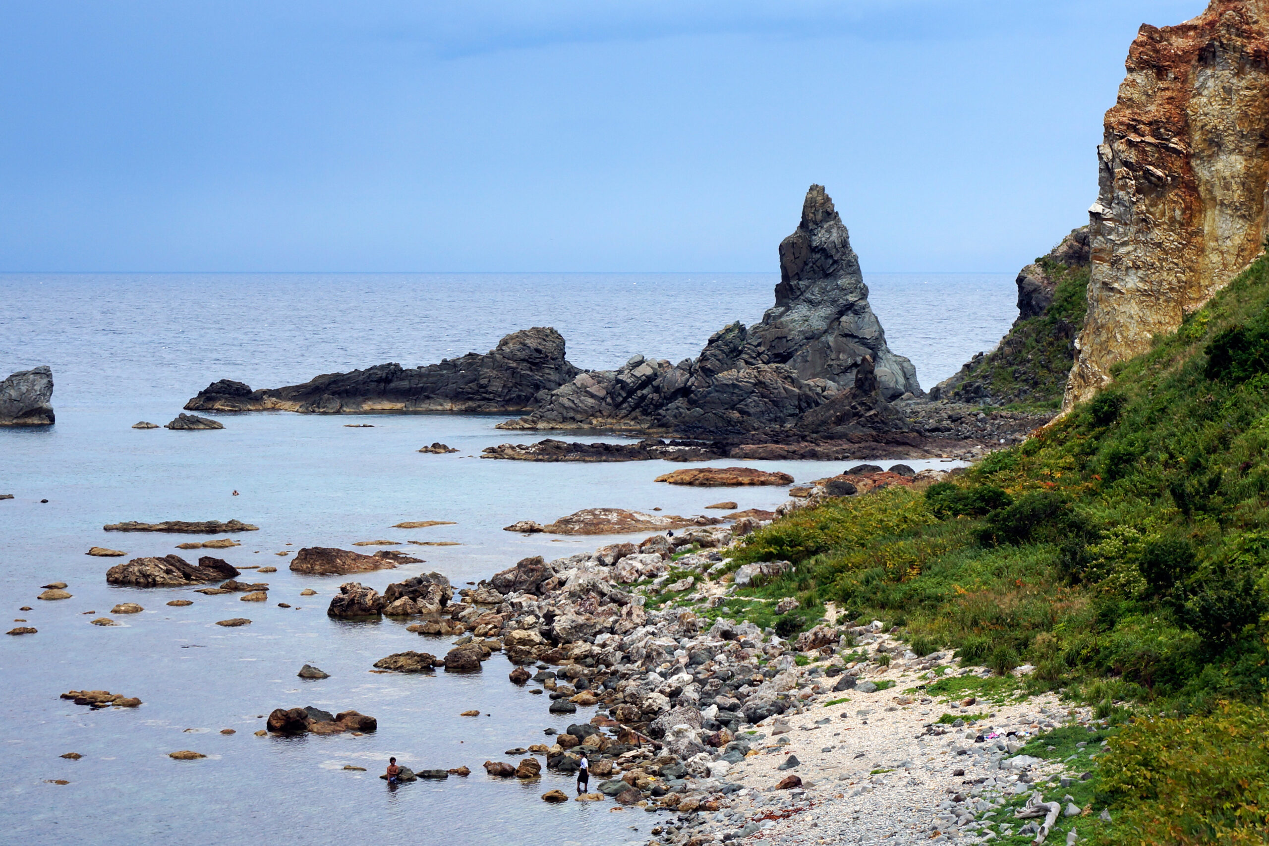 Turquoise water and rocky cliffs of Shimamui Coast, one of Japan's 100 most beautiful beaches