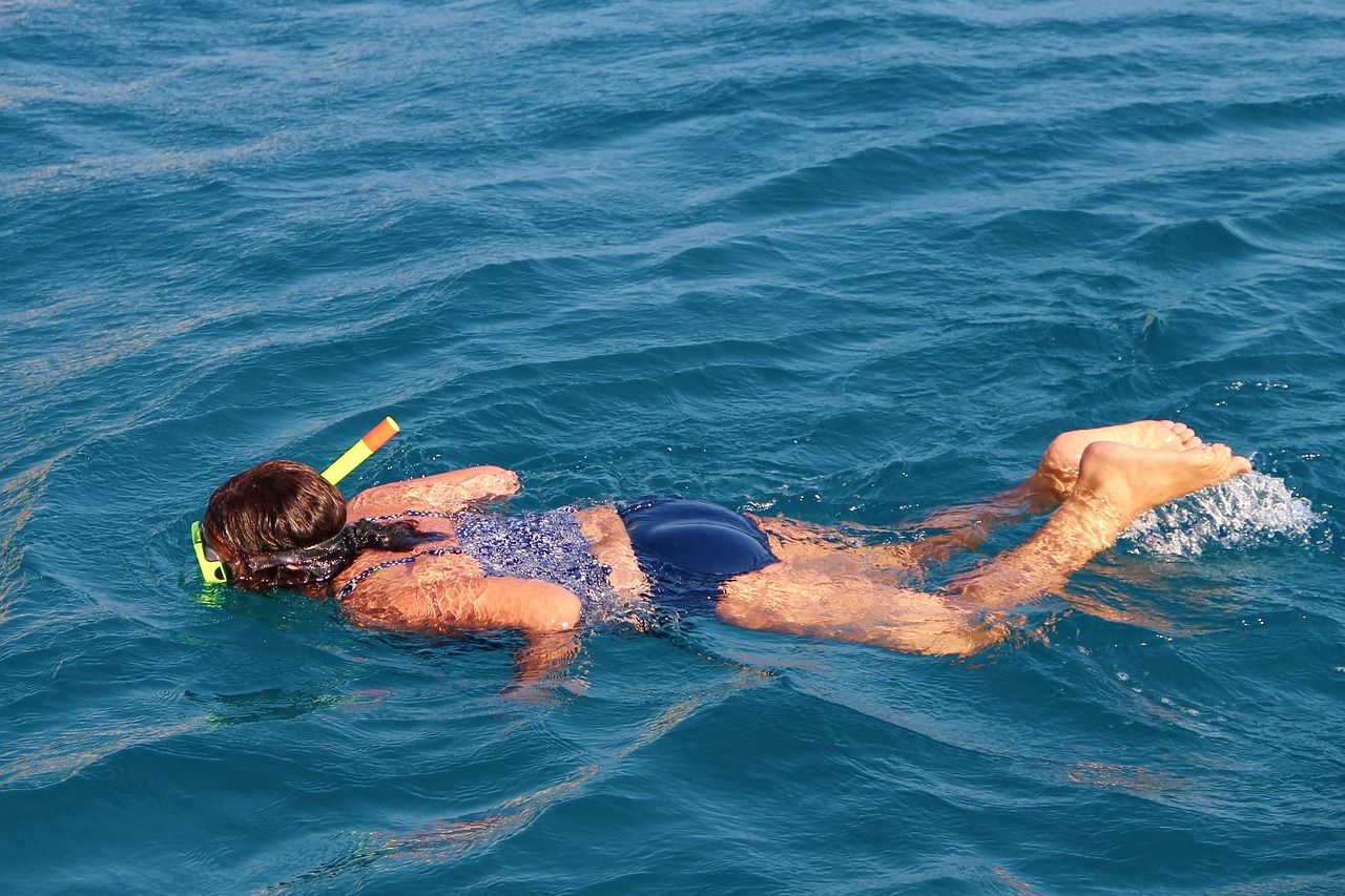Person snorkeling in clear blue water