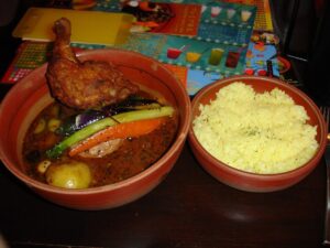 Bowl of soup curry with vegetables and chicken at PICANTE restaurant in Sapporo